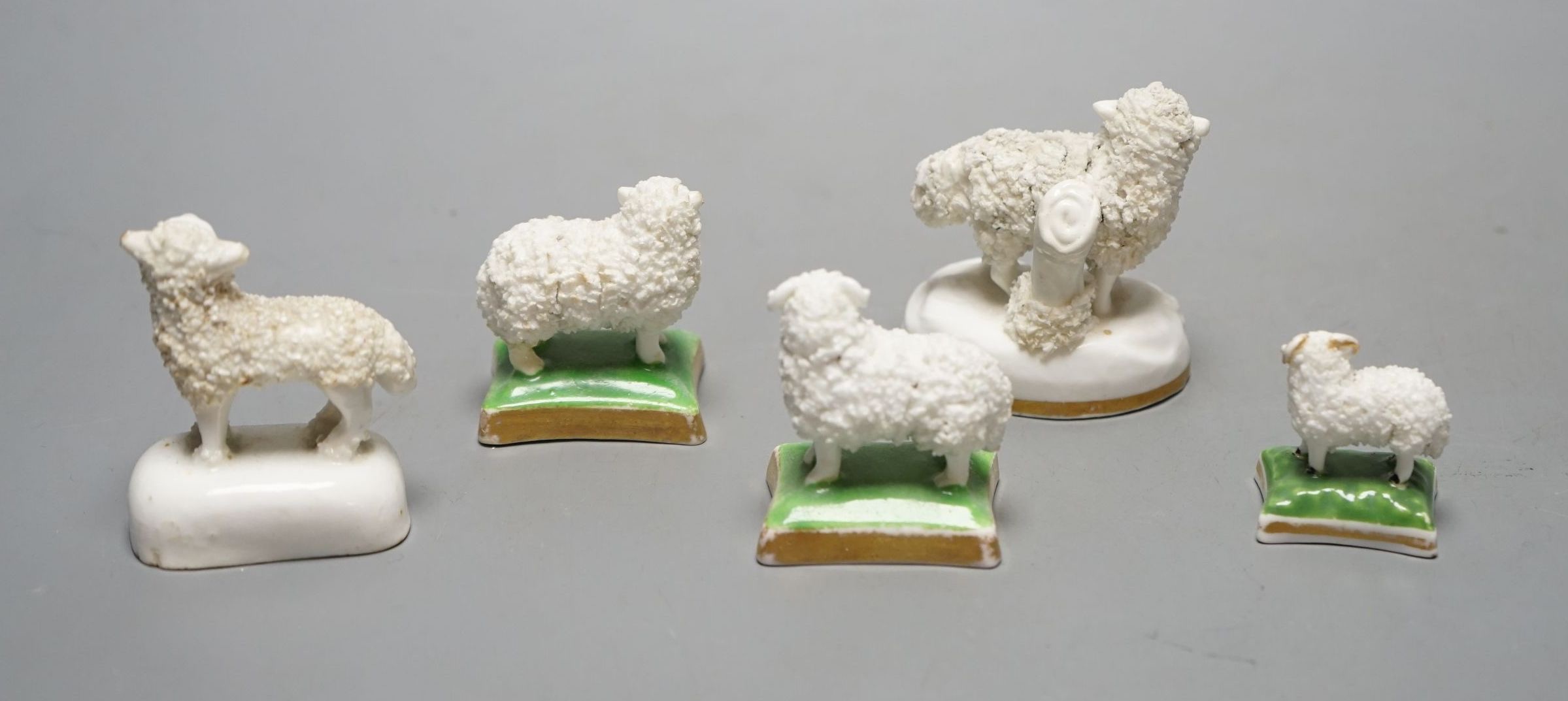 Five Staffordshire porcelain toy models of sheep, c.1830–50, including a pair of a ewe and a ram with green and gilt bases. Provenance: Dennis G. Rice collection, largest 6 cms high.